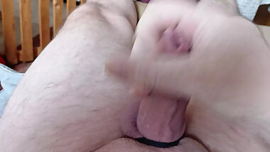 lies and jerks his cock on the couch until he orgasms