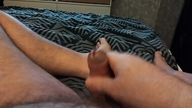 My friend's boyfriend is lying in bed jerking off and playing with his little cock